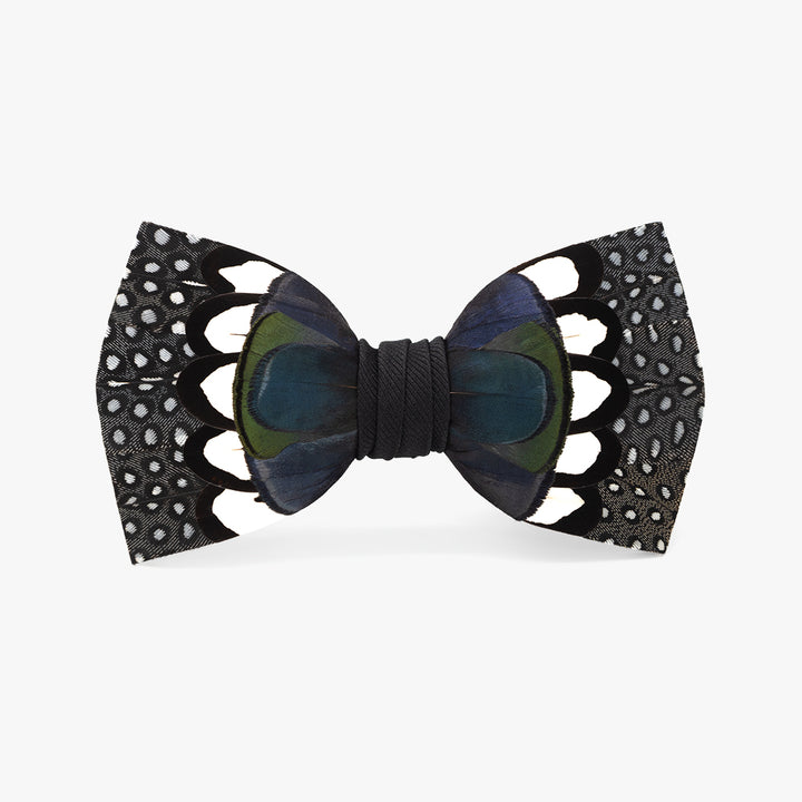 Stylish 'Edisto' bow tie, featuring a bold pattern with black and blue feathers accented by white dots, centered with a dark grosgrain band, for sophisticated and modern formal wear.
