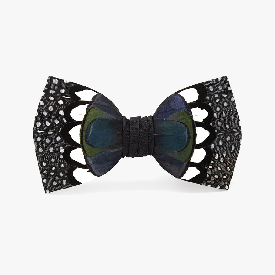 Stylish 'Edisto' bow tie, featuring a bold pattern with black and blue feathers accented by white dots, centered with a dark grosgrain band, for sophisticated and modern formal wear.