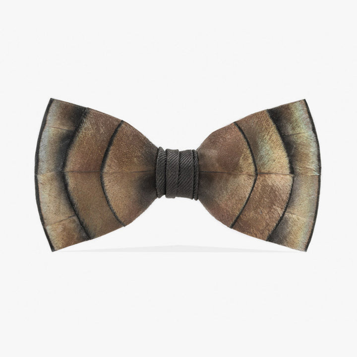 Turkey feather bow tie, featuring an iridescent mix of natural brown, black, and cream tones, centered with a neatly wrapped black core, offering a classic and rustic charm to formal wear.