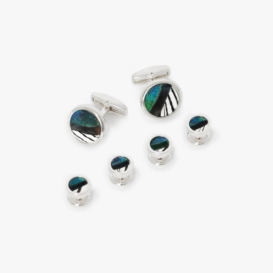 Cufflinks and tuxedo stud set featuring vibrant teal and black iridescent feathers encased in silver rhodium or gold, providing a striking contrast and a dash of opulence to formal attire.