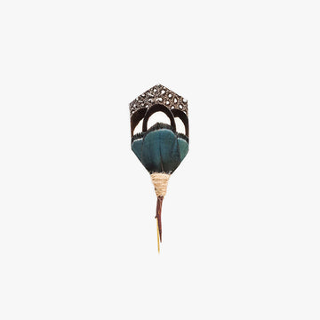 Artistically crafted lapel pin with an array of peacock and pheasant feathers, featuring teal and black hues with a natural tan ruff and a sharp, elongated top.